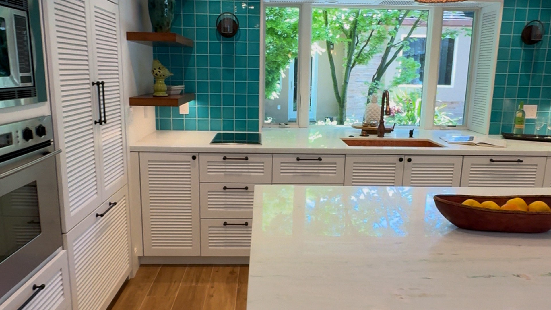 Custom teal backsplash with aligned upper cabinets
